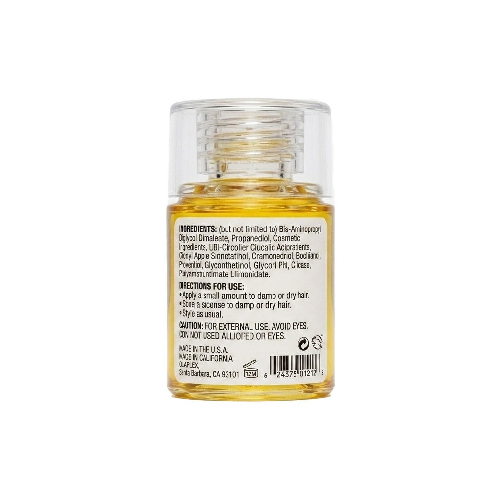 Small glass bottle with yellow liquid on a white background